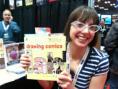Robyn at a convention with her book Drawing Comcis